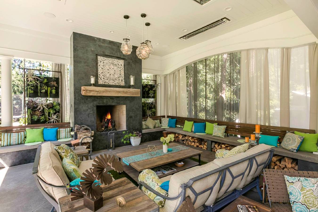 A charming outdoor patio with full ceiling and fireplace.